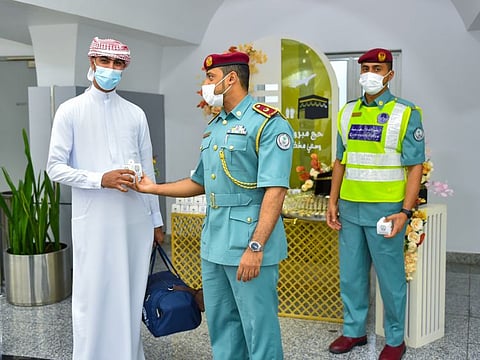 Pilgrims being welcomed by Sharjah Police personnel upon their return from Haj at Sharjah International Airport on Wednesday.