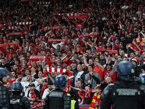 Riot police watch over Liverpool fans at the Stade de France, Saint-Denis near Paris, France during the Champions League final against Real Madrid.