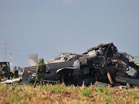 Soldiers of the Mexican Army inspect the wreckage of a Navy helicopter that crashed near the airport of Los Mochis, Sinaloa State, Mexico on July 15, 2022.