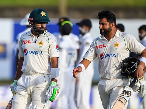 Pakistans Hasan Ali (right) and captain Babar Azam walk back to the pavilion at the end of the first day of play of the first Test against Sri Lanka at the Galle International Cricket Stadium in Galle.