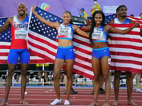 Third placed Allyson Felix (second left), Elija Godwin, Vernon Norwood and Kennedy Simon of the US are all smiles after the Mixed 4x400 Metres Relay final on first day of World Athletics in Eugene, Oregon.