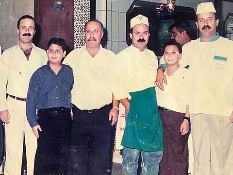 Sweet success: Mahmoud Hanoun (extreme left) and his two brothers Munir and Jamal with other members of the family. Al Aqssa Sweets, which they run, was recently recognised as an 'Urban Treasure' by the authorities in Abu Dhabi.