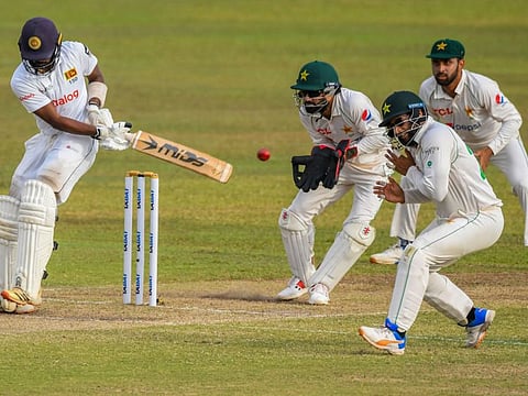 Sri Lanka's Oshada Fernando (left) plays a shot as Pakistans Wicketkeeper Mohammad Rizwan (second left) watches during the second day play of the first Test at the Galle International Cricket Stadium in Galle.
