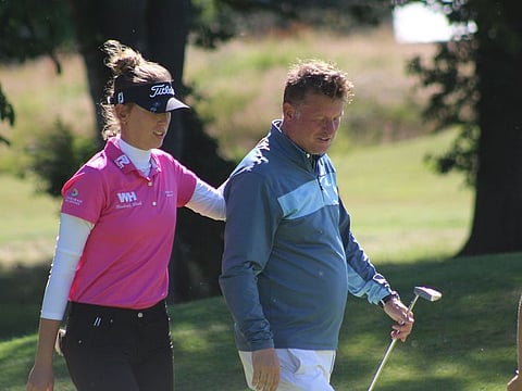Chiara and Tom, her dad and caddie, on the golf course.
