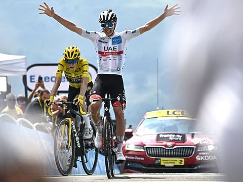 UAE Team Emirates team's Slovenian rider Tadej Pogacar (right) celebrates as he cycles to the finish line ahead of Jumbo-Visma team's Danish rider Jonas Vingegaard to win the 17th stage of the 109th edition of the Tour de France cycling race, 129,7 km between Saint-Gaudens and Peyragudes, in southwestern France.