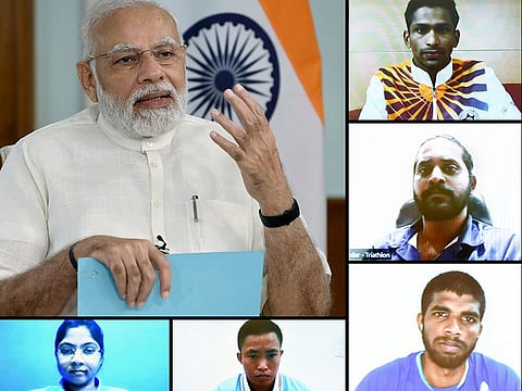 Indian Prime Minister Narendra Modi interacts with some of the members of Commonwealth Games-bound Indian contingent on Wednesday.