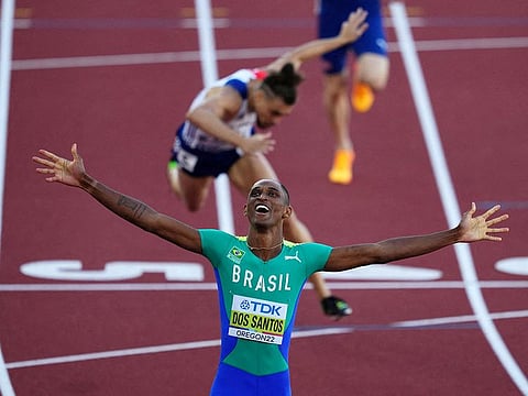 Brazil's Alison dos Santos celebrates after winning the men's 400 metres hurdles final and setting a new world championship record on Tuesday.