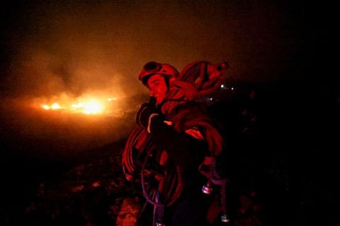 A firefighter works during a wildfire in Ntrafi, near Athens, Greece July 19, 2022.