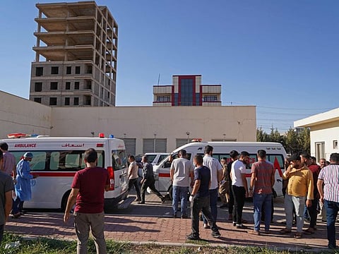 People gather outside a hospital following Turkish shelling in the city of Zakho in the north of Iraq's autonomous Kurdish region on July 20, 2022.