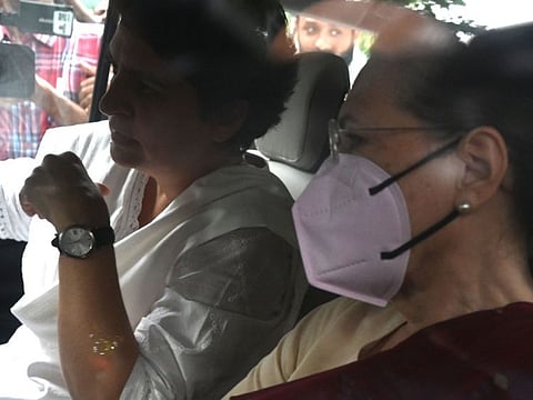 Indian Congress party leader Sonia Gandhi (R) leaves her residence accompanied with her daughter Priyanka Gandhi (L) and her son Rahul Gandhi (not pictured) for questioning in an alleged money laundering case at the Enforcement Directorate (ED) office, in New Delhi on July 21, 2022.