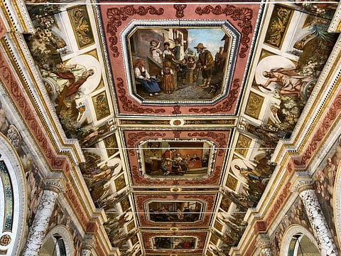 The central row of paintings on the ceiling are oil on canvas, depicting the life of St. Aloysius Gonzaga, the patron saint of the church.