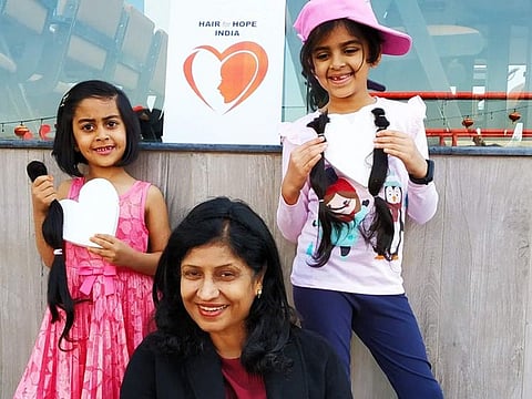 Premi Mathew with two young hair donators.