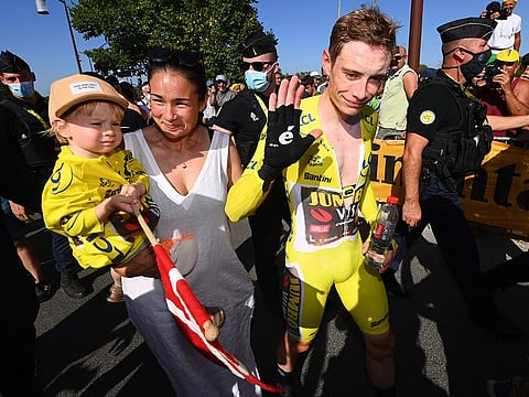 Jumbo-Visma team's Danish rider Jonas Vingegaard, wearing the overall leader's yellow jersey, celebrates alongside his partner Trine and daughter Frida after the 20th stage of the 109th edition of the Tour de France race on Saturday.