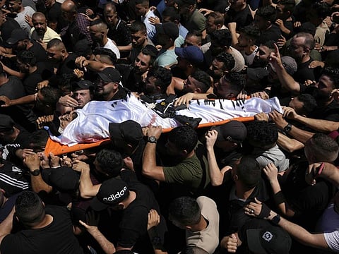 Palestinian mourners carry Aboud Sobh, one of two men killed by Israelin the West Bank city of Nablus, Sunday, July 24, 2022.