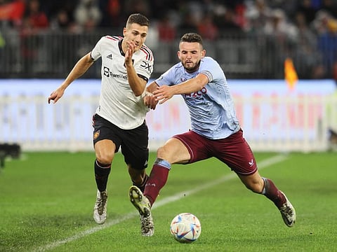 John McGinn of Aston Villa (right) and Manchester United player Diogo Dalot fight for the ball during a friendly match at Optus Stadium in Perth.