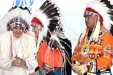Pope Francis wears a headdress presented to him by Indigenous leaders at Muskwa Park in Maskwacis, Alberta, Canada, on July 25, 2022.