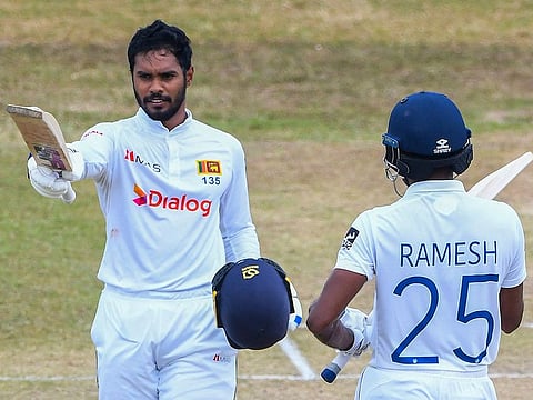Sri Lanka's Dhananjaya de Silva (left) celebrates after completing his century as his teammate Ramesh Mendis applauds during the fourth day of the second Test match.