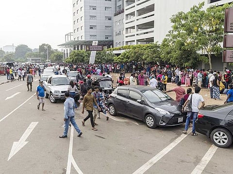 People wait in a line to receive their passports outside the Department of Immigration and Emigration in Colombo, Sri Lanka, on Saturday, July 26, 2022.