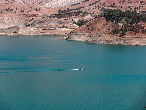 This picture taken on July 2, 2022 shows an aerial view of the Dukan Dam and reservoir northwest of Iraq's northeastern city of Sulaimaniyah in the autonomous Kurdistan region, where waters have been receding due to a mix of factors including lower rainfall, severe drought, and diversion of inflowing rivers from Iran.