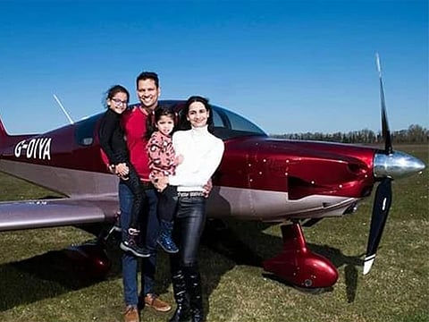 Ashok Thamarakshan with his family, next to the plane built.