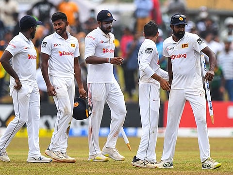 Sri Lanka's left-arm spinner Prabath Jayasuriya (right) celebrates with teammates after Sri Lanka won by 246 runs at the end the of the second Test match against Pakistan at the Galle International Cricket Stadium in Galle on Thursday.