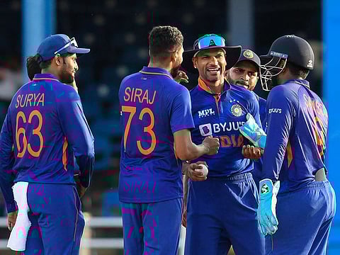 Shikhar Dhawan (centre) celebrates the dismissal of Hayden Walsh Jr of West Indies with his teammates during the third and final ODI match against the West Indies at Queens Park Oval in Port of Spain, Trinidad and Tobago.