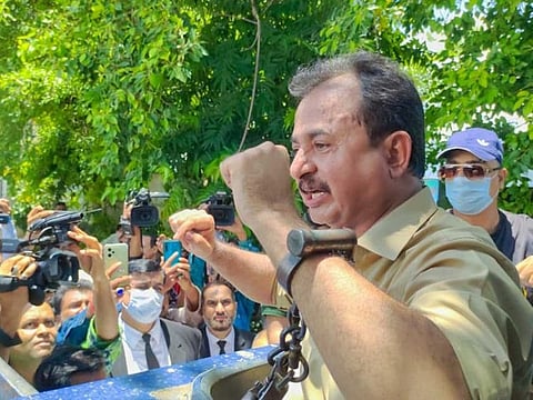 Handcuffed Leader of Opposition in Sindh Assembly, Haleem Adil Sheikh, being produced in Karachi's court after his arrest.