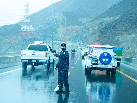 A policeman directs the traffic in rain-affected Fujairah.