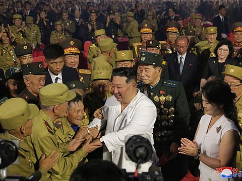 In this photo provided by the North Korean government, North Korean leader Kim Jong Un, centre front, shakes hands with war veterans during a ceremony to mark the 69th anniversary of the signing of the ceasefire armistice that ends the fighting in the Korean War, in Pyongyang, North Korea Wednesday, July 27, 2022.