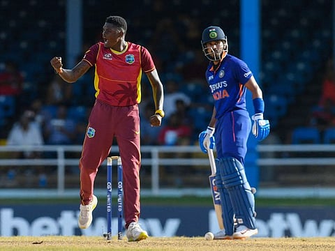 West Indies Alzarri Joseph (left) celebrates the dismissal of India Hardik Pandya during the T20I match at Brian Lara Cricket Academy in Tarouba, Trinidad and Tobago.