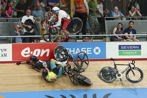 Riders crash on the final lap in the men's 15km scratch race qualifying during the Commonwealth Games track cycling at Lee Valley VeloPark in London.