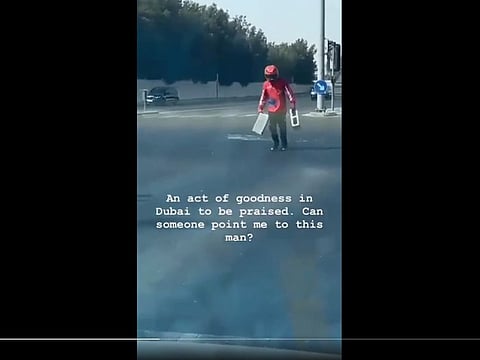 Screengrab from the video shows the rider, whose name is Abdul Ghafoor, picking up concrete blocks from the junction
