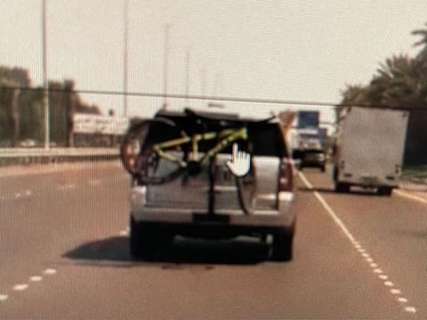 A vehicle plate blocked by a cycle.