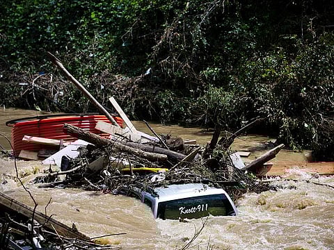 A truck is washed away by floodwaters in the Troublesome Creek near Main Street, in Hindman, Kentucky, on Monday, August 1, 2022.