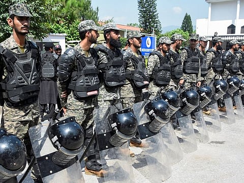 Paramilitary soldiers stand guard for security measures following the Pakistan election commission rules former Prime Minister Imran Khan's party received illegal funds, in Islamabad on August 2, 2022. Imran Khan’s party has decided to file two petitions challenging the ruling.