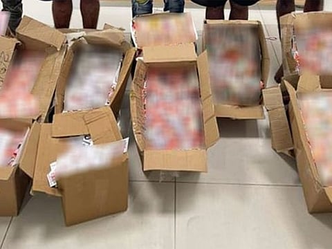Boxes of fake massage centre cards that were seized during the raids.