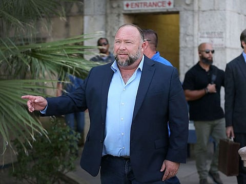 Alex Jones steps outside of the Travis County Courthouse, to do interviews with media after he was questioned under oath about text messages and emails by lawyer Mark Bankston, in Austin, Texas, U.S. August 3, 2022.