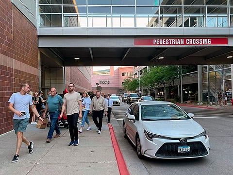 Customers leave the Mall of America after a lockdown was lifted in a shooting, where police have said no victim was found and a suspect has fled, Thursday, Aug. 4, 2022 in Bloomington, Minneapolis.