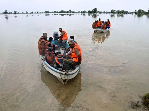 Pakistan army soldiers evacuate villagers from a flooded area in Rajanpur, a district in the central Pakistan, on August 2, 2022. Rains and flash floods have killed at least 550 people across the country since June. The deluges have also completely destroyed or damaged nearly 37,000 homes in the flood-hit areas.