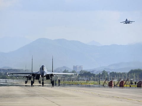 In this photo released by China's Xinhua News Agency, air force and naval aviation corps of the Eastern Theatre Command of the Chinese People's Liberation Army (PLA) fly planes at an unspecified location in China, Thursday, Aug. 4, 2022.