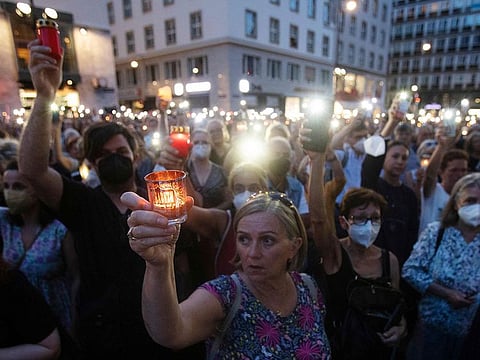 This file photo taken on August 1, 2022 shows people attending a candle light memorial at Stephansplatz for Lisa-Maria Kellermayr, the deceased Austrian doctor who closed her practice after she reported receiving death threats from opponents of COVID-19 restrictions and vaccines in Vienna, Austria.