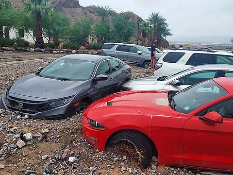 Cars are stuck in mud and debris from flash flooding at The Inn at Death Valley in Death Valley National Park, California on August 5, 2022.