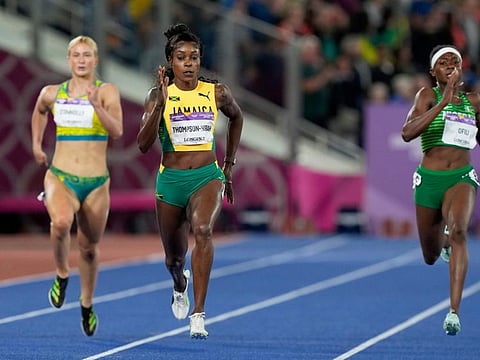 Elaine Thompson-Herah of Jamaica runs to win the gold medal in the Women's 200 meters during the athletics competition in the Alexander Stadium at the Commonwealth Games in Birmingham, England. At left is Ella Connolly of Australia and at right silver medalist Favour Ofili of Nigeria.