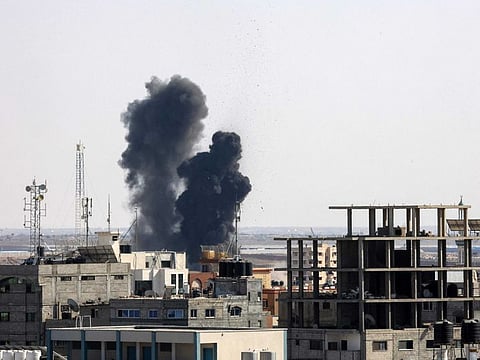 Smoke billows from a building struck during an Israeli air strike in Rafah in the southern Gaza Strip, on August 7, 2022.
