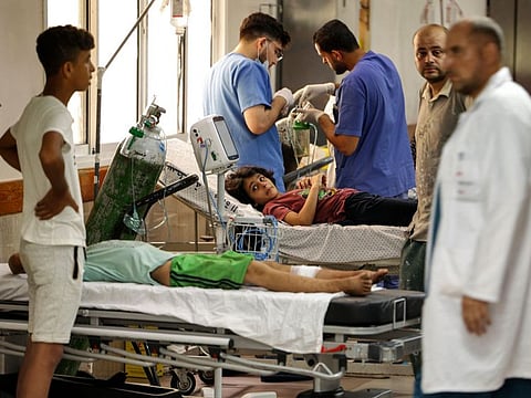 Palestinian children receive treatment at Al Shifa hospital in Gaza City on August 6, 2022.
