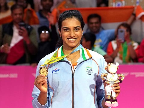 India's Venkata Sindhu Pusarla poses with her gold medal in the Women's singles badminton at the Commonwealth Games in Birmingham, England.