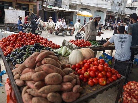 Palestinians buy fresh produce from street stalls in Rafah town in the southern Gaza Strip, as a truce with Israel holds following three days of conflict, on August 8, 2022.