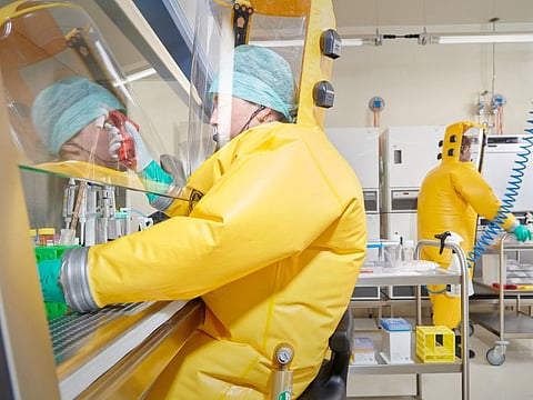 Employees of Spiez Lab work in the BSL-4 facility that is available to the World Health Organisation (WHO) as a repository for SARS-CoV-2 viruses or other pathogens with epidemic or pandemic potential, in this handout picture in Spiez, Switzerland.