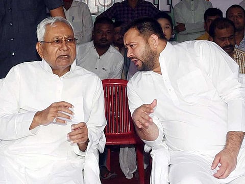 Bihar Chief Minister Nitish Kumar interacts with Deputy CM Tejashwi Yadav while attending an event on Martyrs Day at Shaheed Smarak, in Patna on Thursday, Aug 11, 2022.