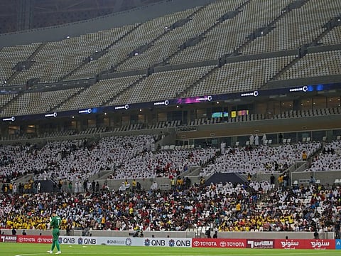 Fans attend the Qatar Stars League match between Al Arabi and Al Rayyan at the Lusail Stadium. This is the first official match at the 80,000-capacity venue that is to host this year's World Cup final.